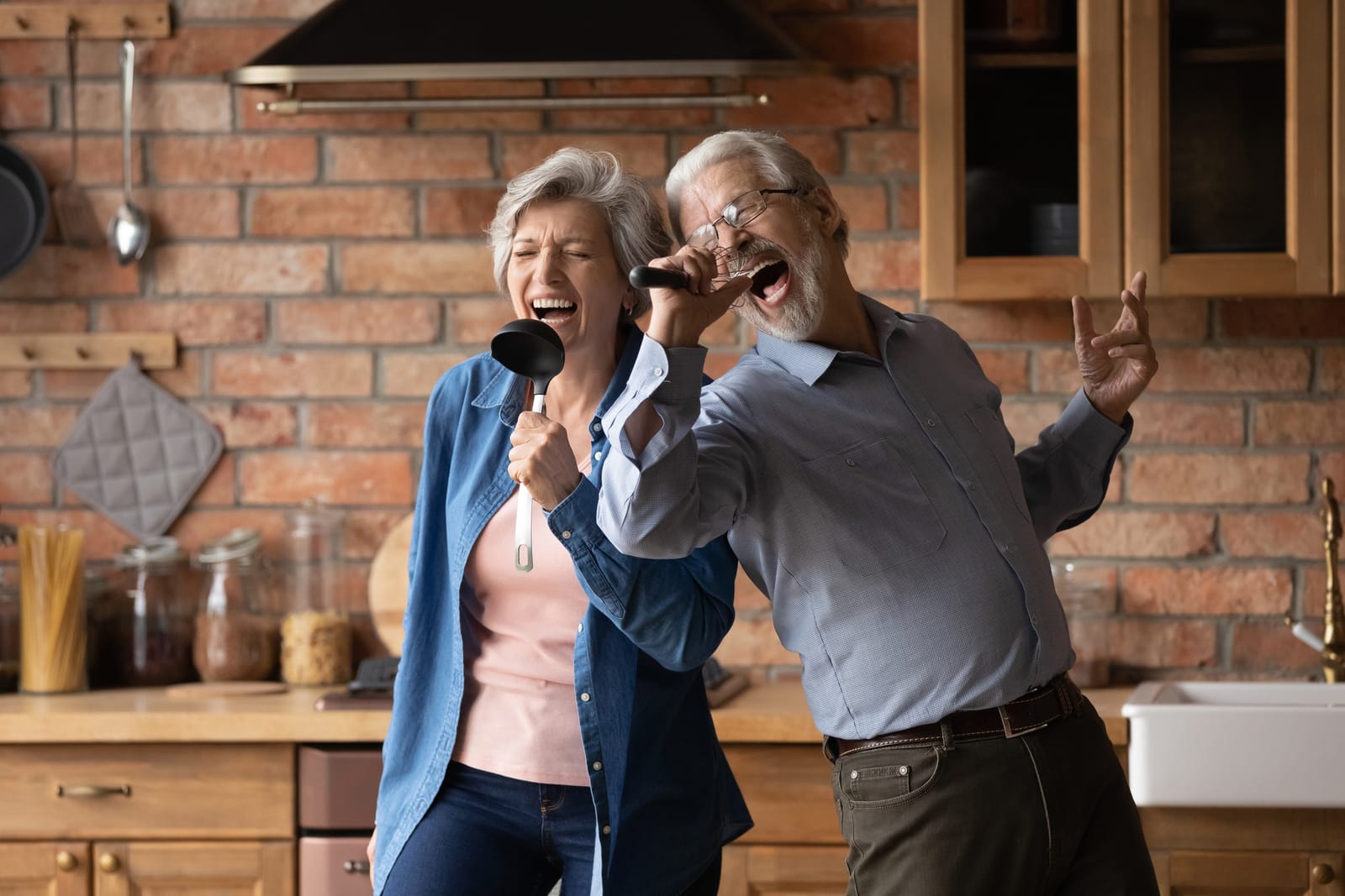 Senior Couple Singing Kitchen Ladles